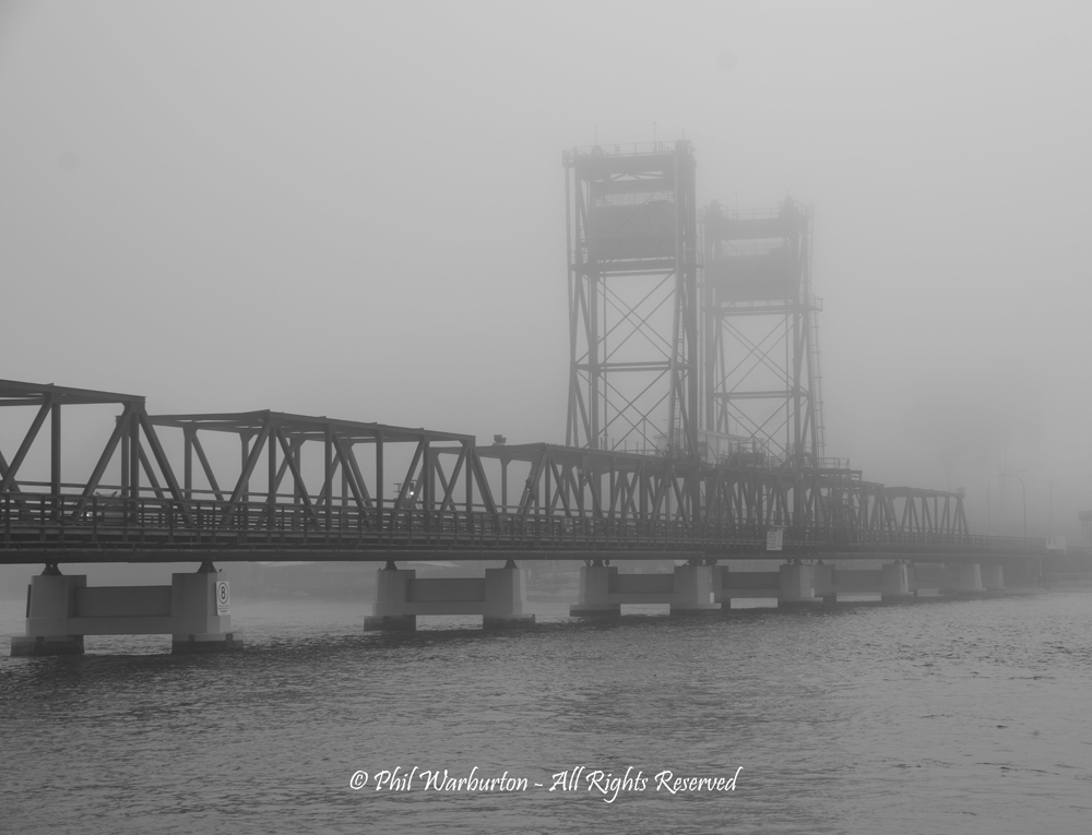 Bridge in the mist by Phil Warburton